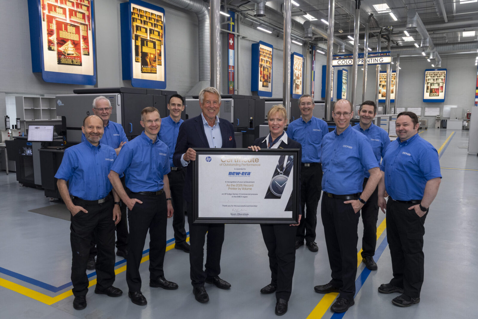 Zara Kotric, CEO of New Era Publications International (center right), receives the 2026 Record Printer by Volume award from Lars Renneby, Director of Visutech (center left), representing Noam Zilbershtain, Vice President & General Manager of HP Indigo worldwide, during a ceremony at New Era’s publishing and manufacturing facility in Glostrup on July 3, 2026.